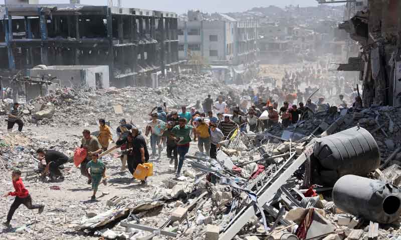 Despite Israeli attacks, Hamas is resurging amid Gaza’s ruins: CNN analyses a group of palestine people walking through a destroyed building