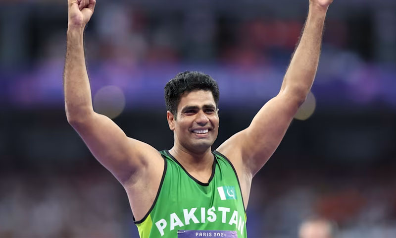 Javelin thrower Arshad Nadeem throws his arms up in celebration