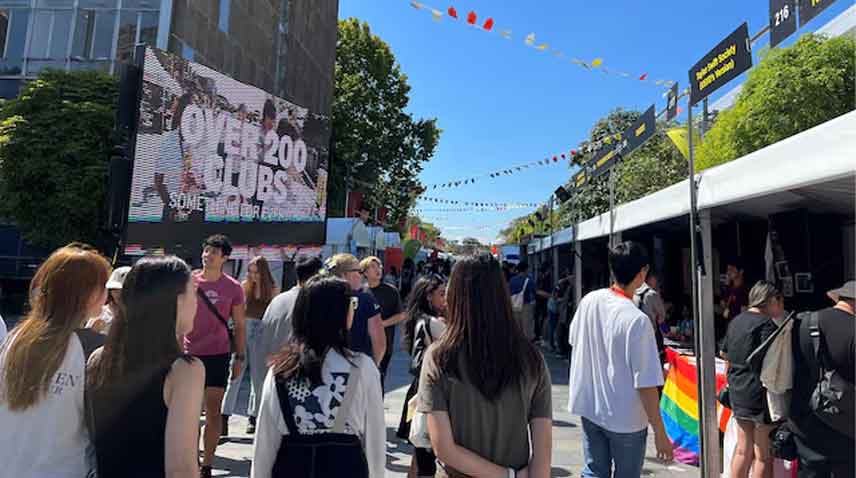 Students walk past stalls during the orientation week at The University of Sydney, in Camperdown, Australia.