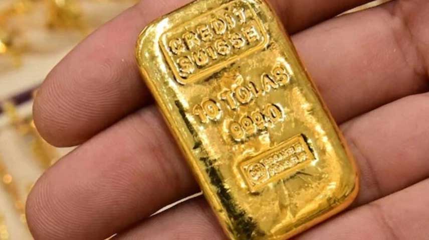 A jeweller shows a gold bar.