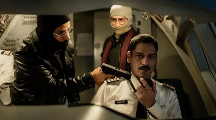 A scene from "IC 814: The Kandahar Hijack" in which hijacker points a pistol at the captain of the flight.