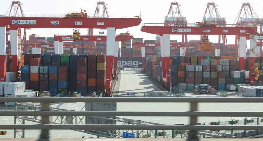China vows to 'fight to the end' as Trump tariff war rages Gantry cranes stand near shipping containers at Yangshan Port outside of Shanghai