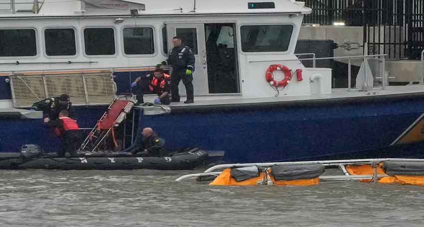 Tourist helicopter crashes into New York's Hudson River, killing all six aboard Rescue workers and emergency personnel work at the scene of a helicopter crash on the Hudson River