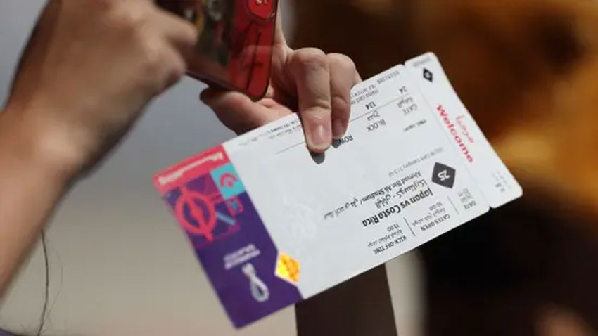 General view of a fan holding a match ticket inside the stadium before the match. via Reuters
