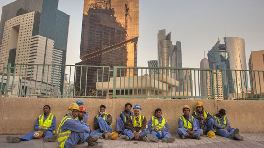 Workers sitting aside a wall in Middle East. File Photo