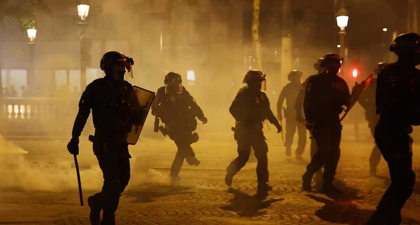 Riot police on the Champs Elysees avenue after Paris St Germain won the Champions League REUTERS