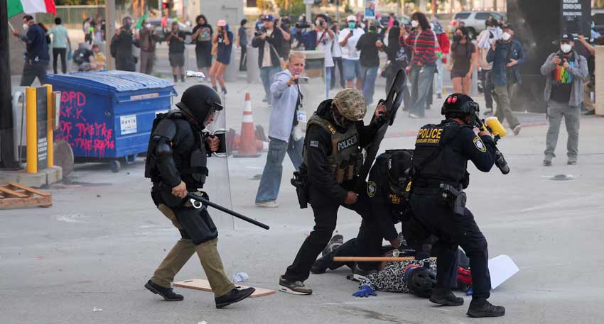 Riot police, anti-ICE protesters square off in Los Angeles after raids