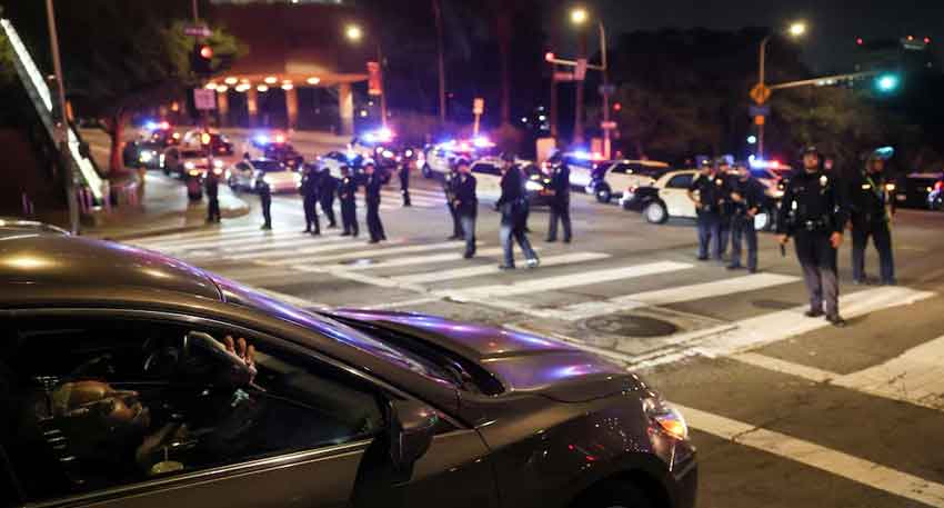 Trump wants to 'liberate' Los Angeles, residents say 'no thanks' A man in a car uses his mobile phone as members of law enfocement stand guard on a road after curfew, as protests against federal immigration sweeps continue Los Angeles - REUTERS