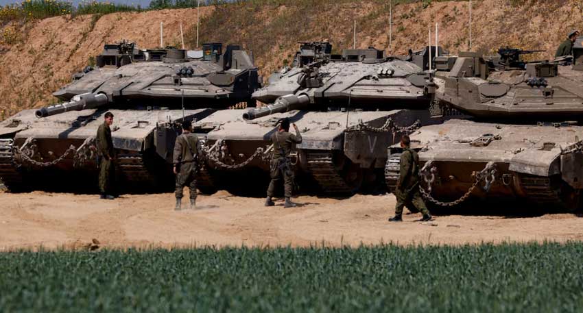 Israel may seize all Gaza in expanded operation, officials say Israeli tanks are positioned near the Israel-Gaza border - Reuters