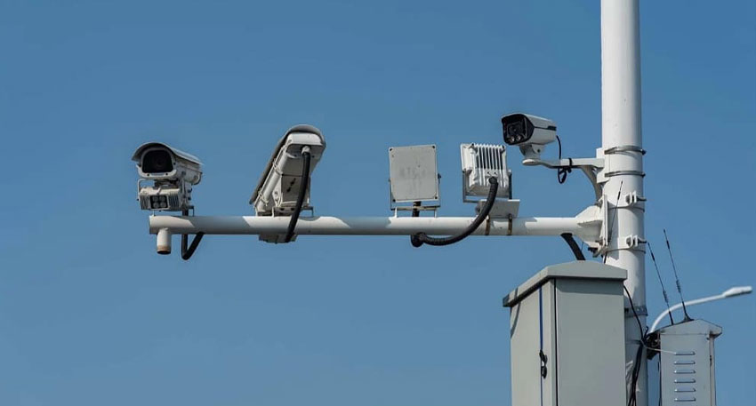 Traffic cameras and equipment on a pole.