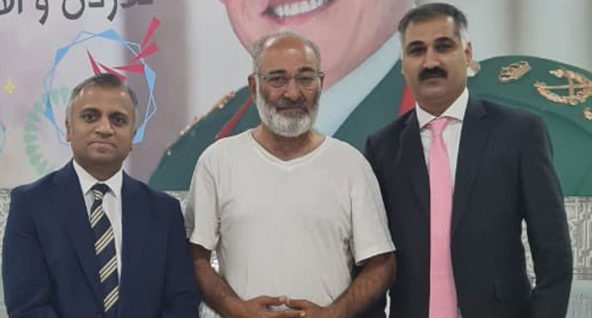 Former Senator Mushtaq Ahmad Khan stands with Pakistani embassy officials at the Pakistan Embassy in Amman