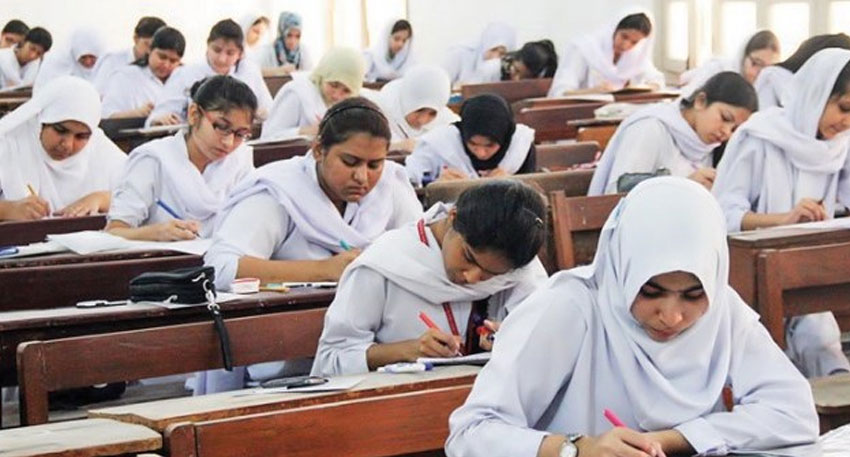 How to check BISE Lahore board 11th class results 2025 Female students in Pakistan taking an intermediate board exam in a classroom
