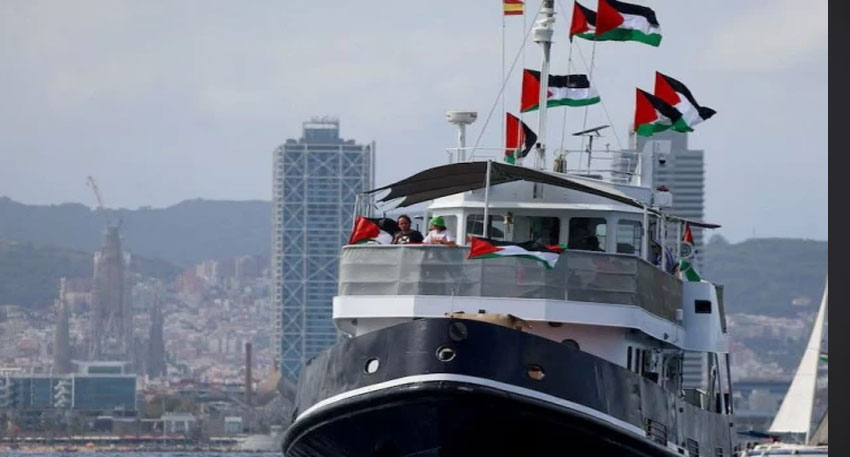 A ship carrying Palestinian flags sails near the coast during a solidarity demonstration.