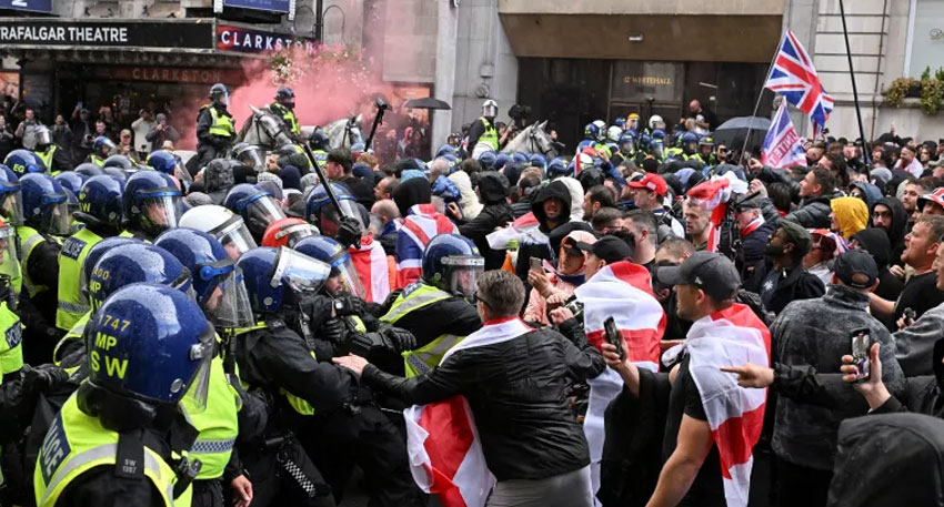 Police officers clash with British anti-immigration protesters during a rally in London
