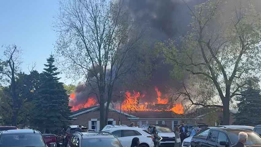People gather at the site as smoke and fire rise in Grand Blanc, Michigan, U.S., September 28, 2025. Reuters 