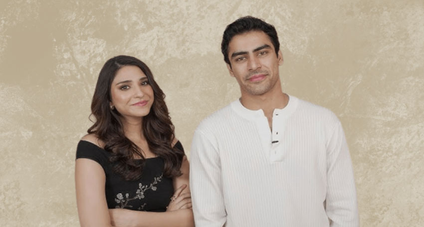 Pakistani actors Ramsha Khan and Khushhal Khan posing together against a neutral, textured backdrop.
