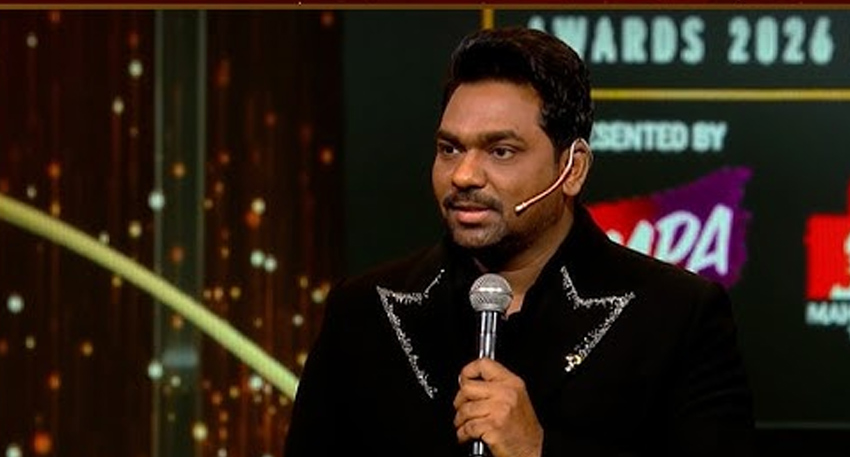 Zakir Khan speaking into a microphone on stage at the Screen Awards 2026.