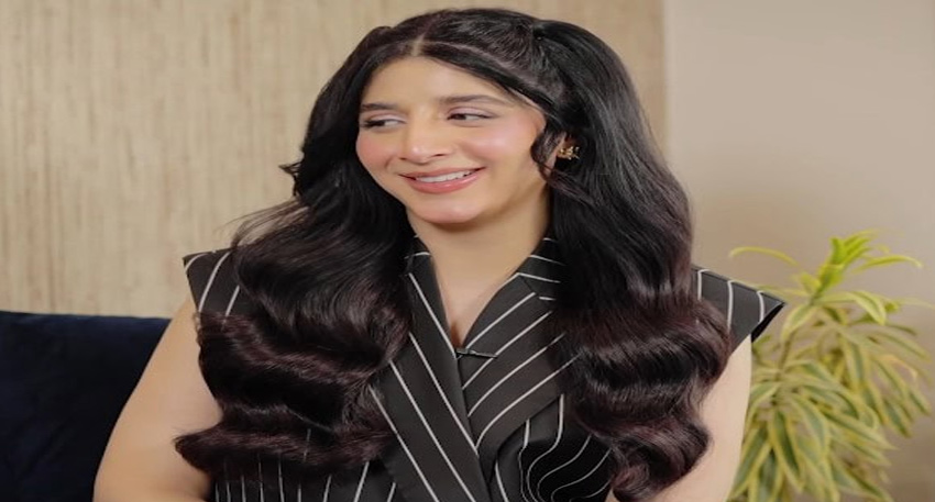 Mawra Hocane in a black pinstriped vest with wavy hair, smiling during a recent appearance.