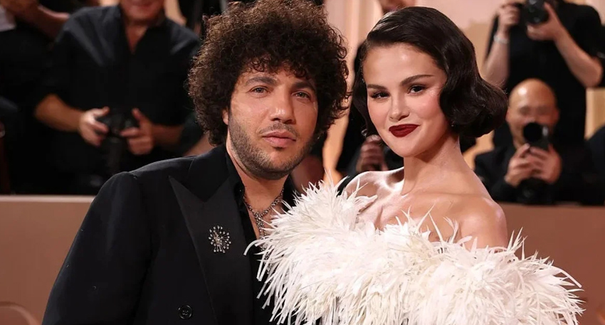 Selena Gomez and Benny Blanco posing together at an awards ceremony.