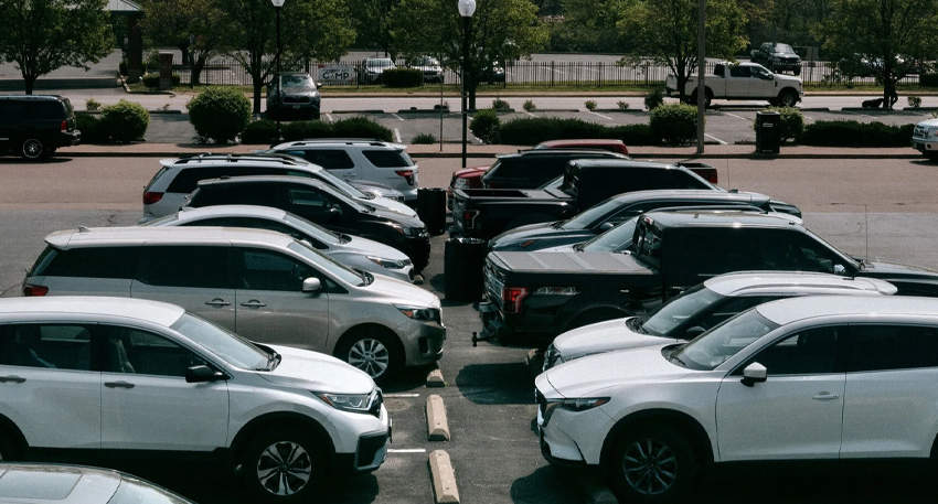 Cars parked in rows at an outdoor commercial parking lot in Islamabad.
