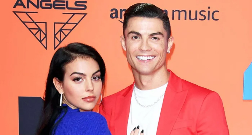 Cristiano Ronaldo and Georgina Rodriguez smiling together at a red carpet event.