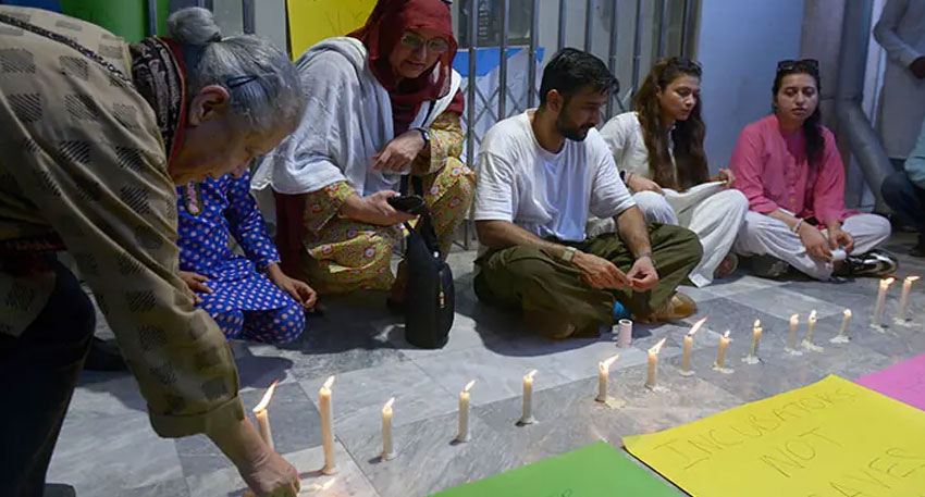 Grieving men gathered near a vehicle at the PIMS mortuary following a hospital tragedy.