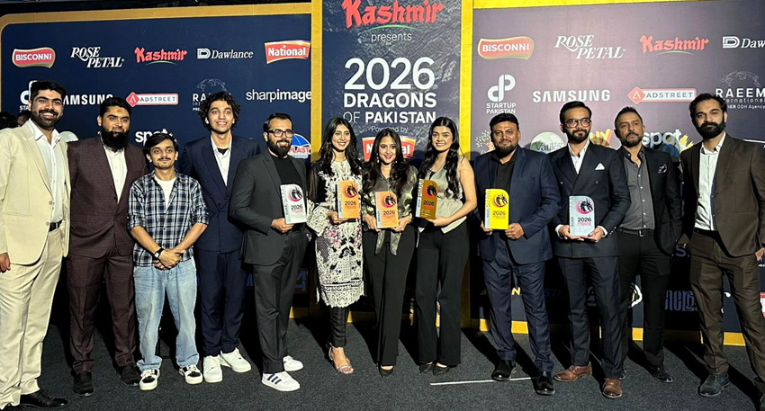 Group photo of award winners holding trophies at the Dragons of Pakistan 2026 event.