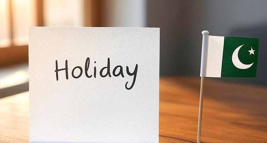 A white card with the word 'Holiday' written on it next to a small Pakistan flag.