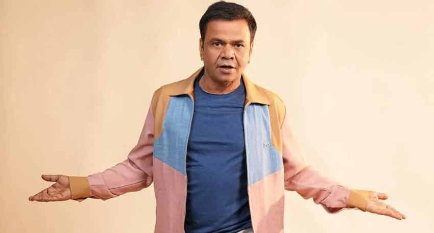 Rajpal Yadav in a black outfit poses for a photo.
