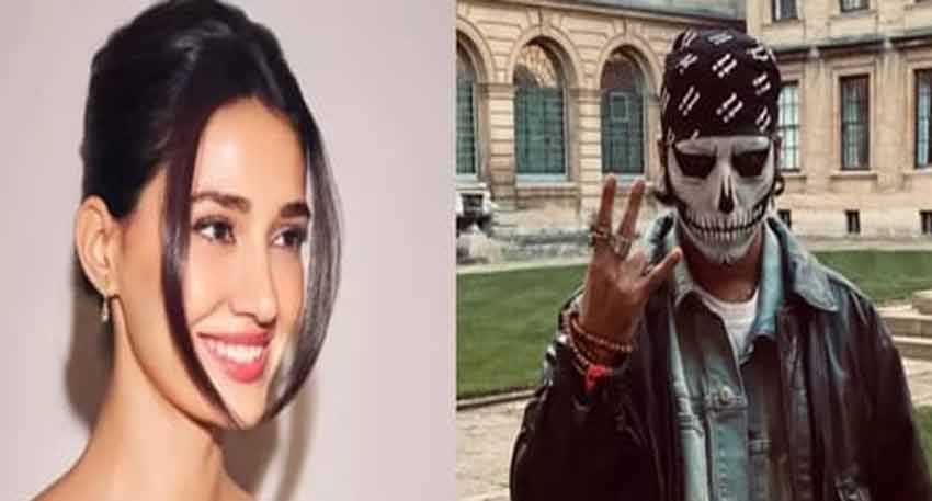 Actress Disha Patani smiles alongside singer Talwiinder, who is wearing a skeleton face mask and bandana.