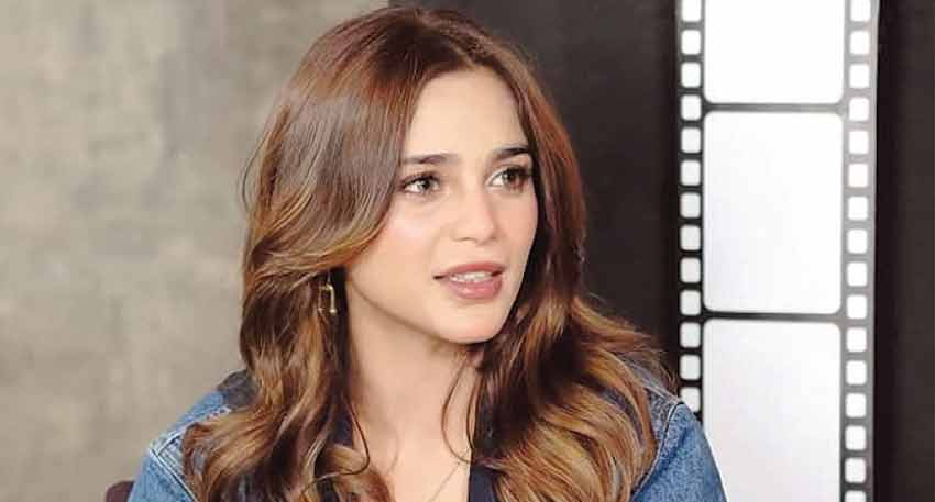 Pakistani singer Aima Baig in a close-up shot during an interview, wearing a denim jacket.