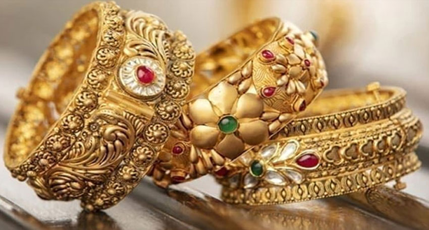 Gold slips from record high as silver hits new peak