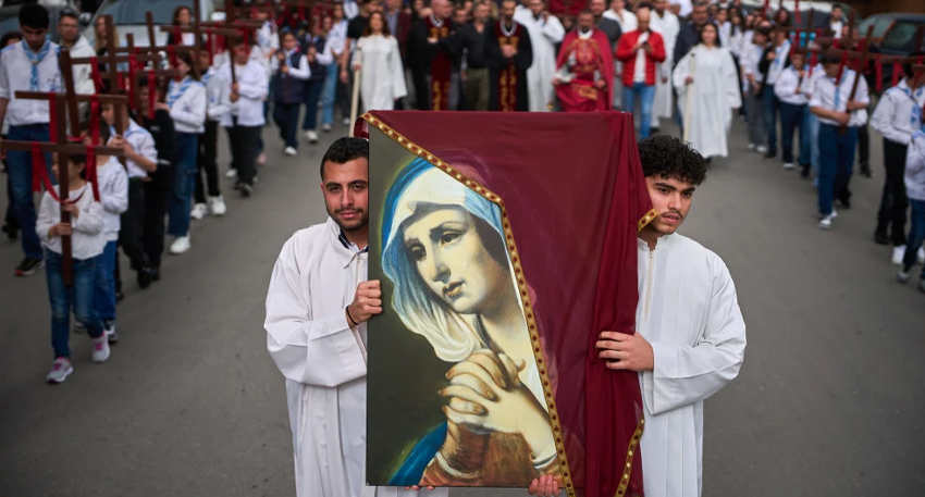 Parishioners walk in a procession after a Good Friday Mass at St. Anthony Church in Beirut, which was devoted to expressing solidarity with Christian villagers in southern Lebanon displaced by the war