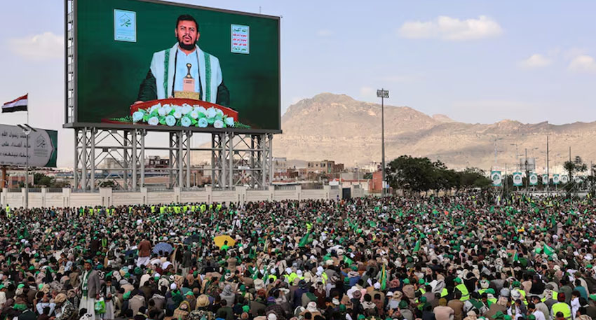 Abdul-Malik al-Houthi appears on a screen as people, mainly Houthi supporters, gather to mark the Prophet Muhammad's birthday, at Sabeen Square in central Sanaa. Reuters