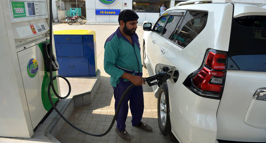 Man refueling white SUV at PSO petrol station.