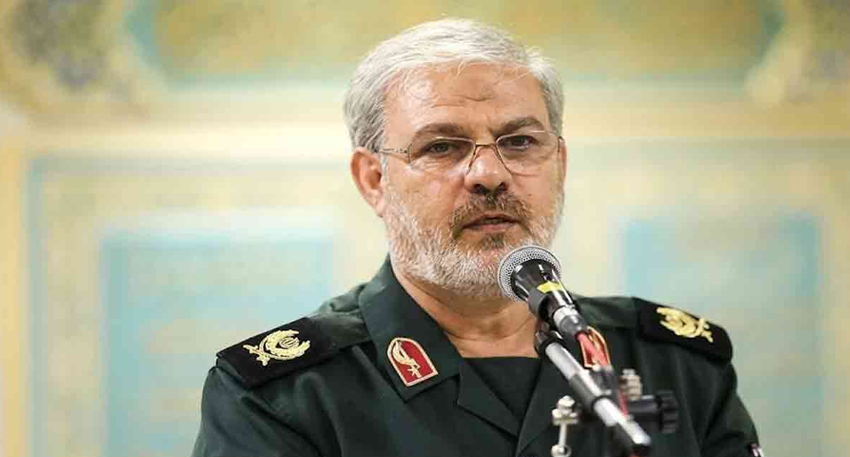 IRGC spokesperson Brigadier General Hossein Mohebi speaking at a microphone.