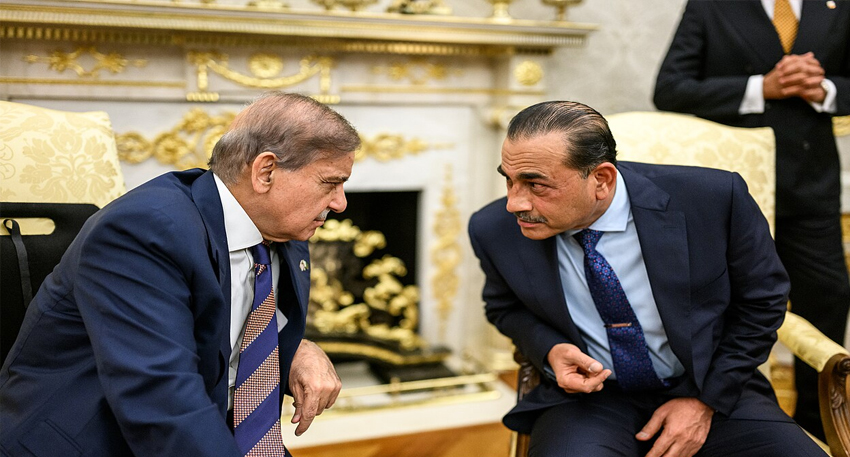 Pakistani PM Shehbaz Sharif and Field Marshal Asim Munir conversing closely in formal suits.