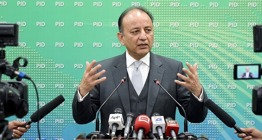 Dr. Musadik Malik gestures at a podium with microphones during a press conference on the Indus Waters Treaty.