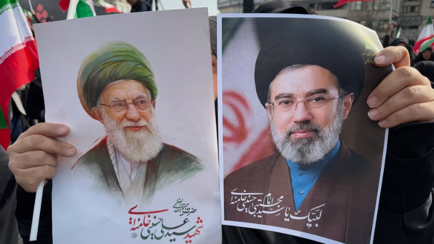 A woman holds an image of Iran's new supreme leader Mojtaba Khamenei alongside late Iranian Supreme Leader Ayatollah Ali Khamenei. File photo