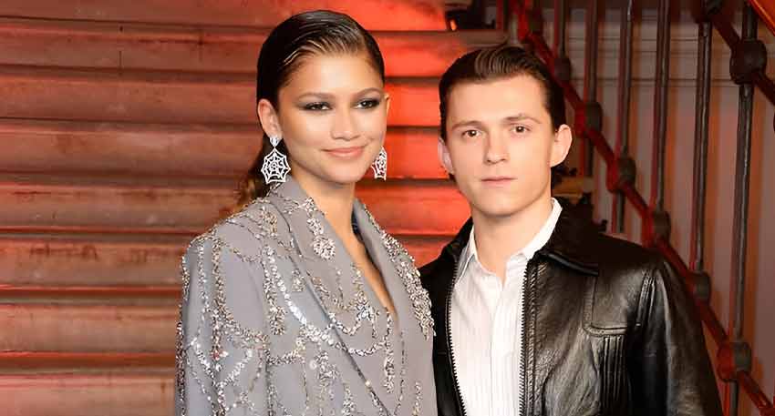 Zendaya and Tom Holland pose at an event.