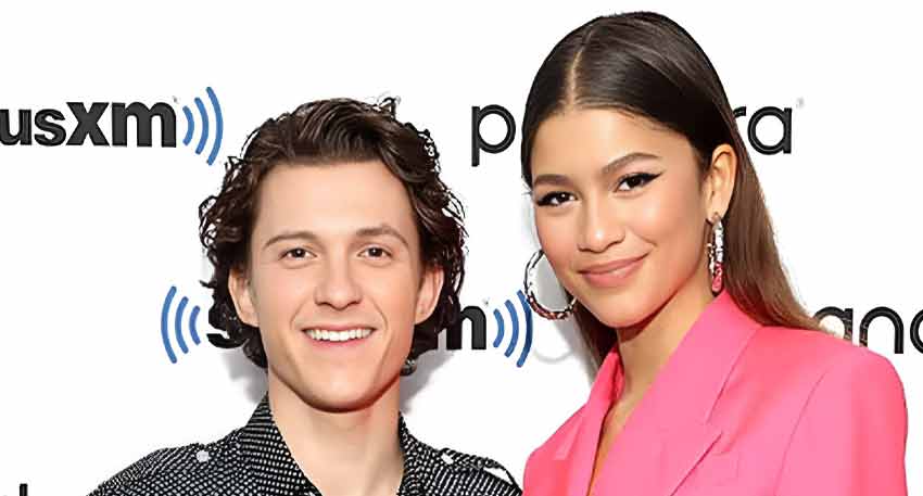 Tom Holland and Zendaya smiling together at a SiriusXM event.