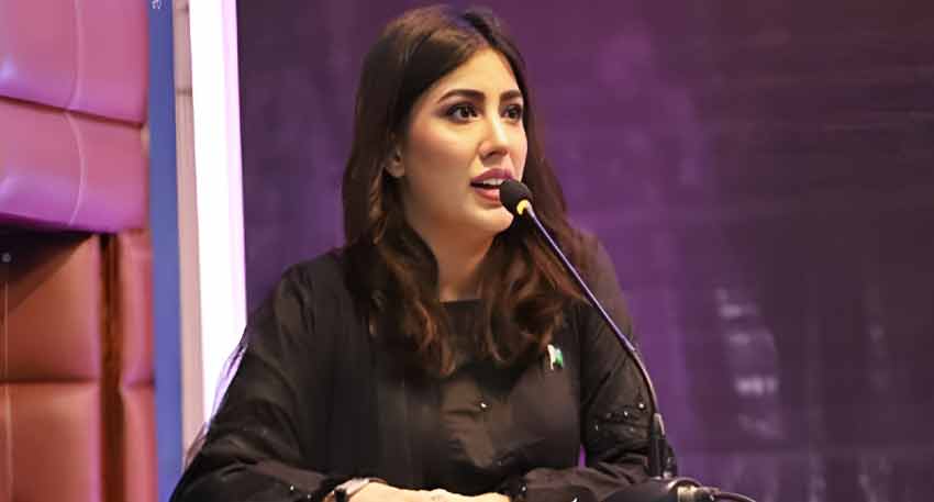 Pakistani actress and activist Mehwish Hayat speaking into a microphone at a public event.