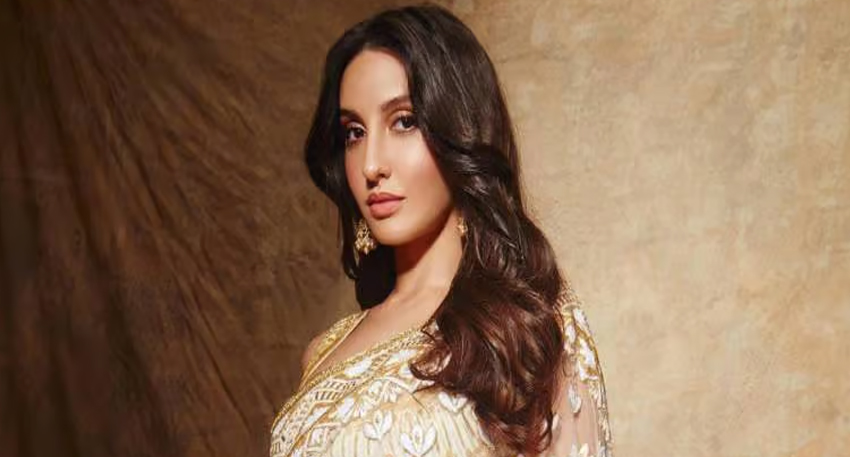 Nora Fatehi, a Canadian dancer and actress, in a traditional gold and white saree.