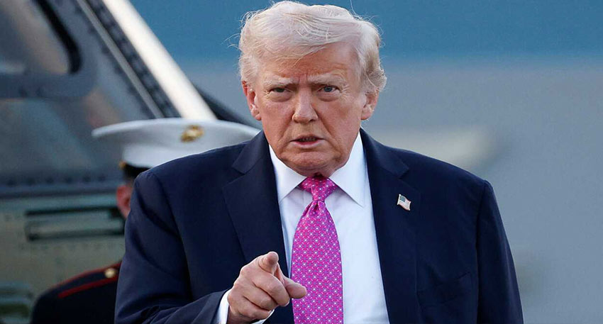 Donald Trump in a suit and pink tie, pointing his finger directly at the viewer.