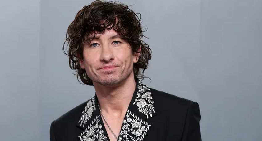 A close-up portrait of actor Barry Keoghan wearing a black jacket with white embroidery.