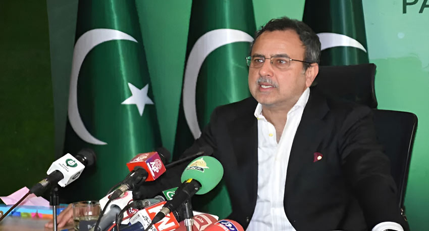 Pakistan's Minister for Power, Sardar Awais Ahmed Khan Leghari, at a press conference with Pakistani flags in the background.