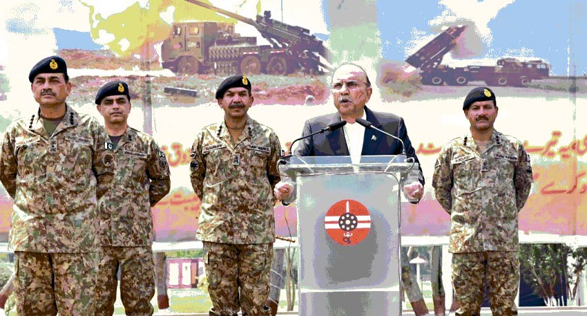 resident Zardari speaks at a podium flanked by military officers and Mohsin Naqvi, with a missile display backdrop.