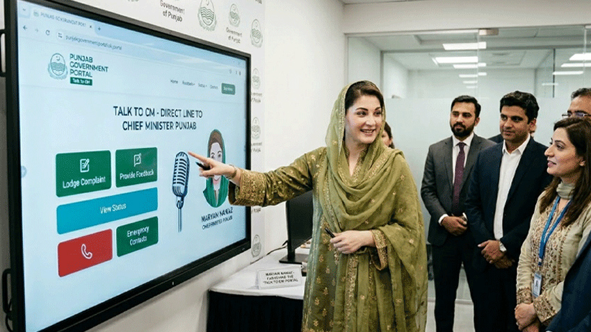Maryam Nawaz pointing at the Talk 2 CM Portal on a large screen while surrounded by officials.