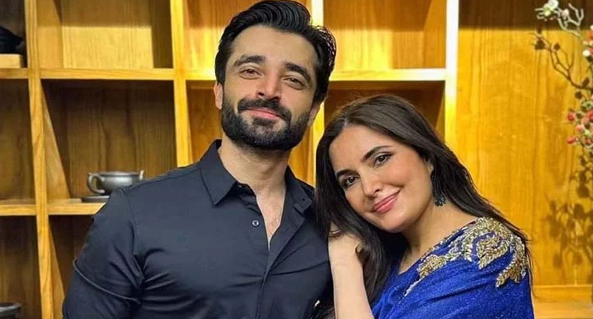 Hamza Ali Abbasi in a black shirt standing next to his sister, Dr. Fazeela Abbasi, in a blue embroidered dress.