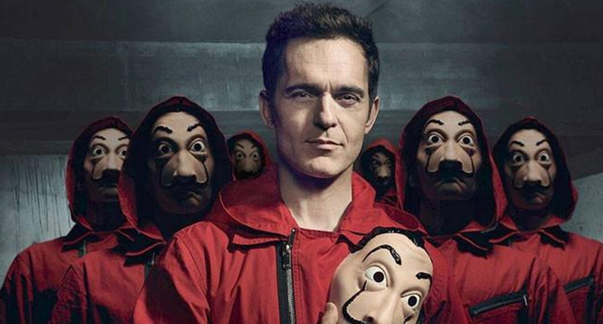 Pedro Alonso as Berlin unmasked, surrounded by a heist crew in red jumpsuits and iconic Salvador Dalí masks.